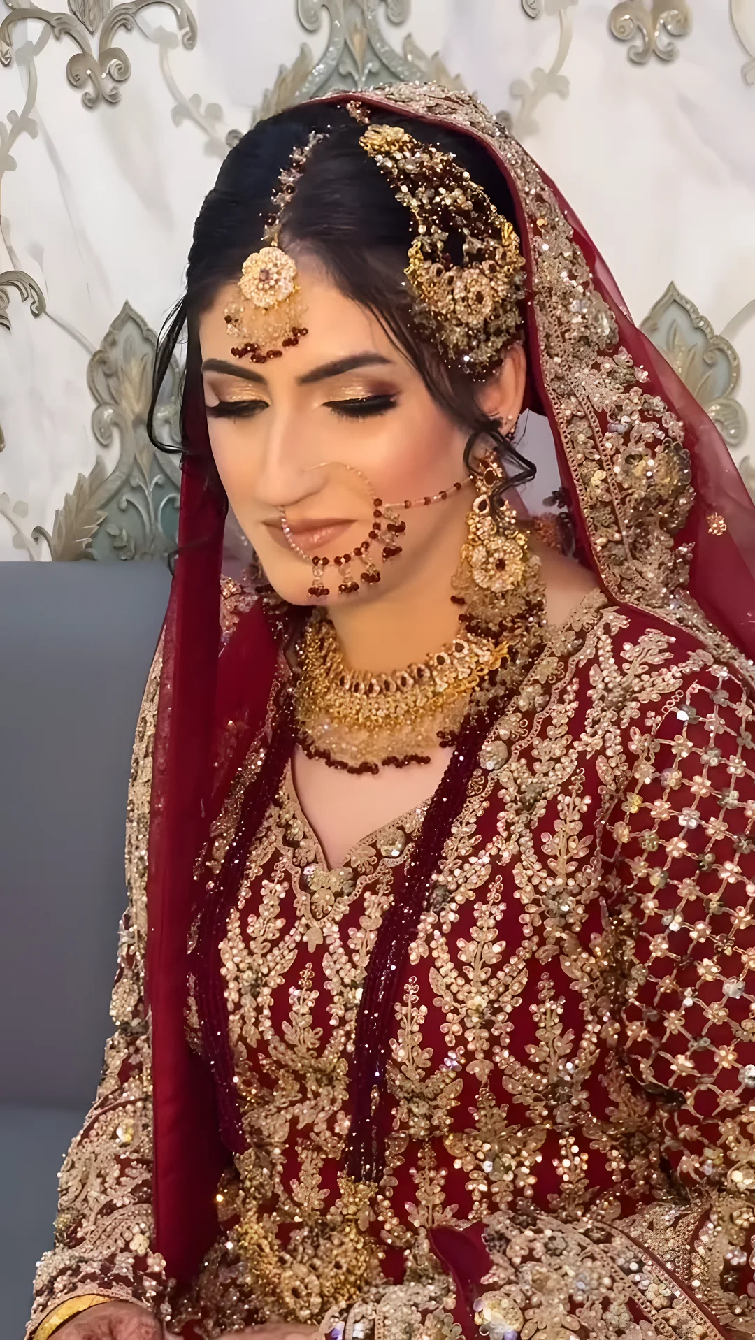 Bride in red and gold bridal makeup